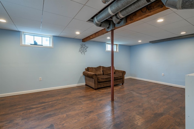 basement with plenty of natural light, baseboards, wood finished floors, and recessed lighting