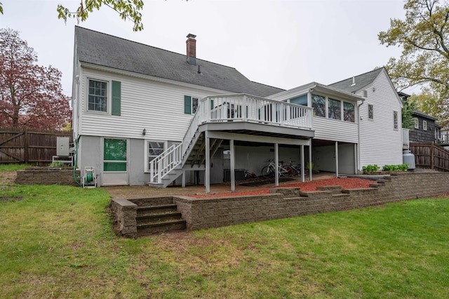 back of house featuring stairs, a deck, a chimney, and roof with shingles