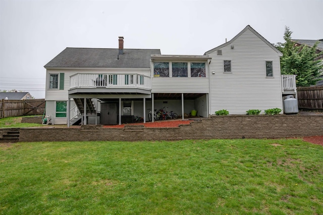 back of property with stairs, a wooden deck, a sunroom, and a chimney
