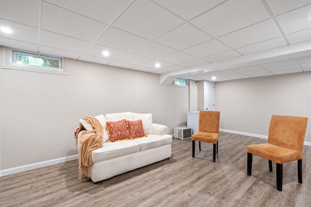 sitting room with wood finished floors, baseboards, recessed lighting, and a paneled ceiling