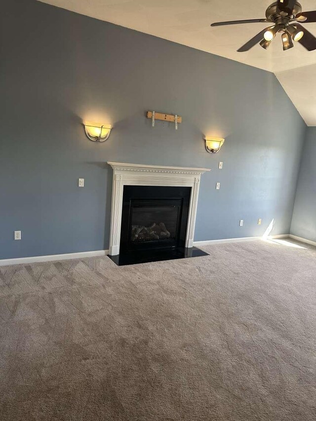 detailed view of carpet floors, a fireplace with flush hearth, a ceiling fan, and baseboards