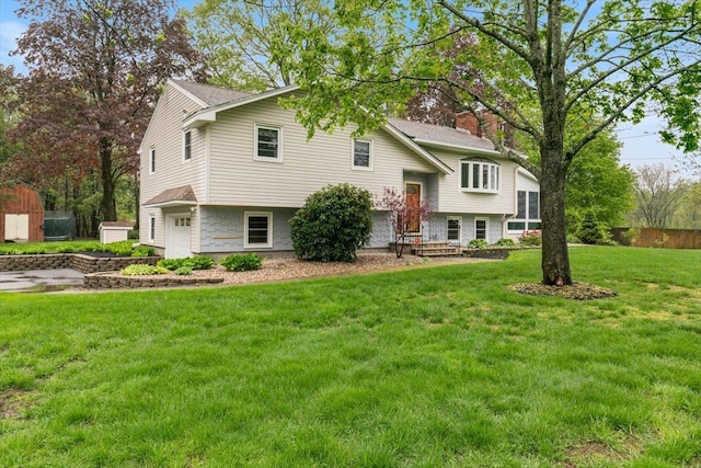 view of front of property featuring a garage, a front yard, and a chimney