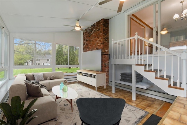 living room featuring a ceiling fan, stairway, lofted ceiling, and baseboard heating
