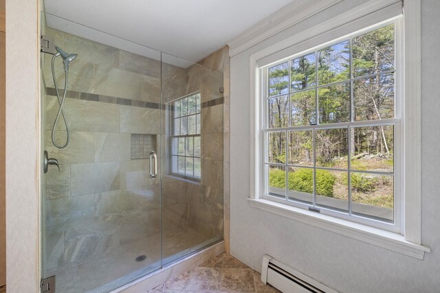full bath featuring plenty of natural light, a shower stall, and a baseboard heating unit