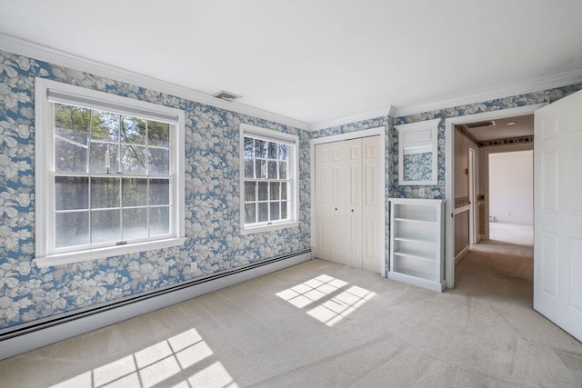 unfurnished bedroom featuring a baseboard heating unit, wallpapered walls, crown molding, light colored carpet, and a closet