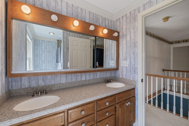 full bath with double vanity and crown molding