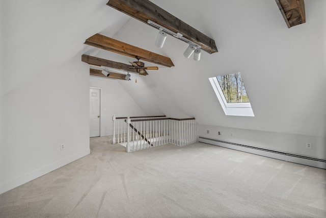 bonus room featuring a skylight, carpet flooring, a baseboard radiator, and baseboards