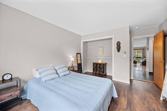 bedroom with dark wood-style flooring and baseboards