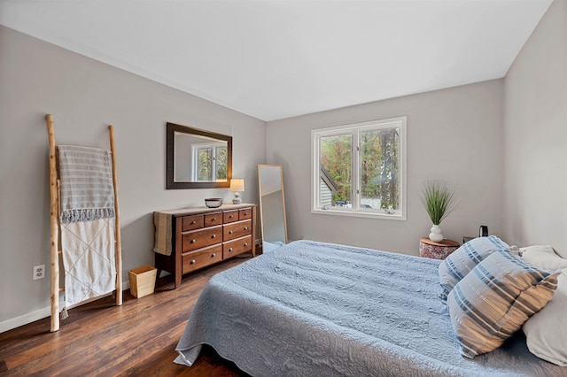 bedroom with dark wood-style flooring and baseboards
