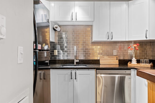 kitchen featuring dishwasher, a sink, backsplash, and white cabinetry