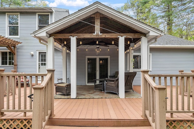 wooden terrace featuring ceiling fan