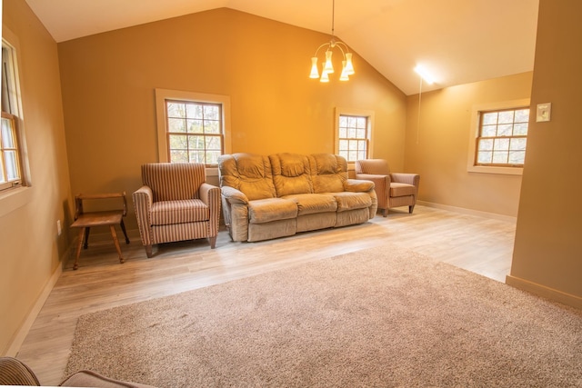43 Parker Ledge Rd, Woodstock, NH 03262 - living room with vaulted ceiling, plenty of natural light, wood finished floors, and a chandelier