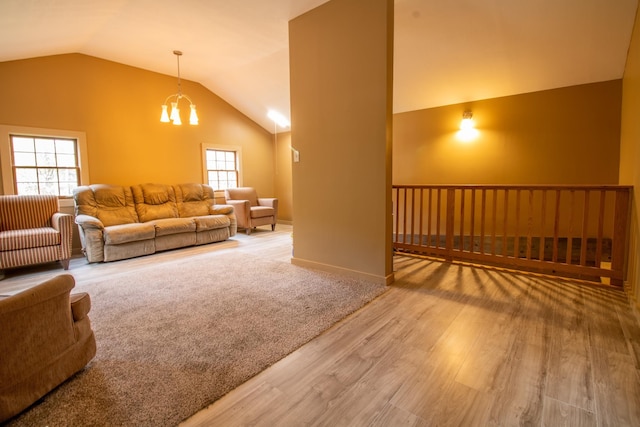 43 Parker Ledge Rd, Woodstock, NH 03262 - living room featuring vaulted ceiling, wood finished floors, a chandelier, and plenty of natural light