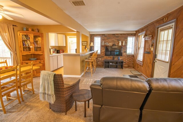 43 Parker Ledge Rd, Woodstock, NH 03262 - living room featuring light carpet, plenty of natural light, a ceiling fan, and wood walls