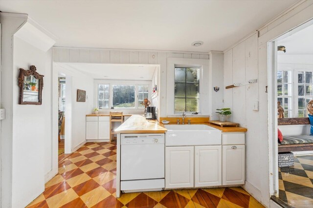 144 Parsons Rd, Dublin, NH 03444 - kitchen featuring white dishwasher, light flooring, a sink, and white cabinetry