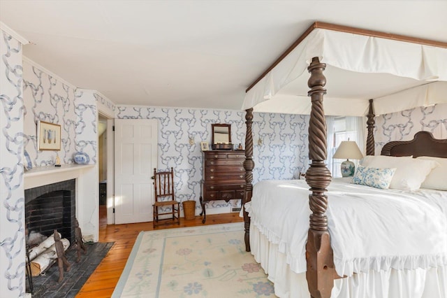 144 Parsons Rd, Dublin, NH 03444 - bedroom with light wood-style flooring, wallpapered walls, and a fireplace