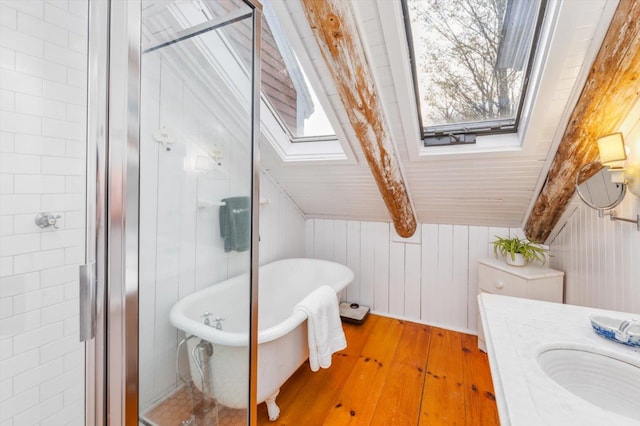 144 Parsons Rd, Dublin, NH 03444 - full bath featuring a skylight, hardwood / wood-style flooring, a freestanding tub, a sink, and wooden walls