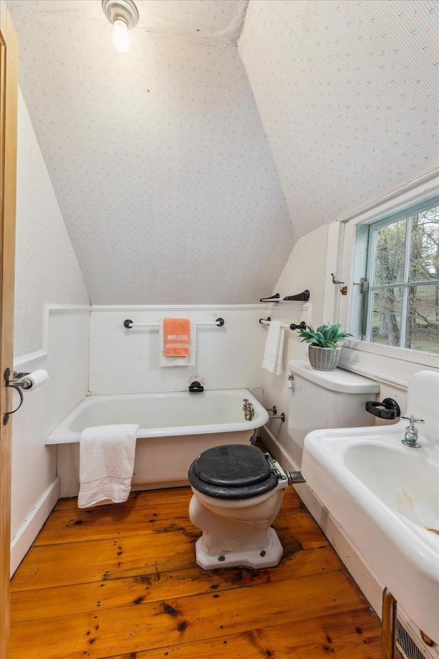 144 Parsons Rd, Dublin, NH 03444 - bathroom with lofted ceiling, toilet, a freestanding bath, hardwood / wood-style flooring, and baseboards