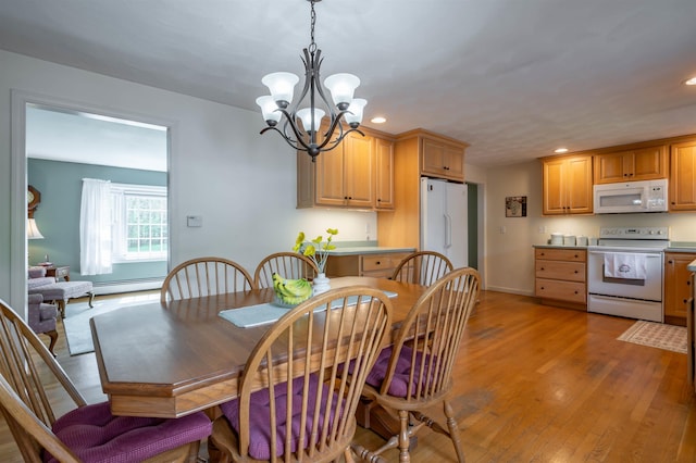dining space featuring a chandelier, recessed lighting, light wood finished floors, baseboards, and a baseboard heating unit