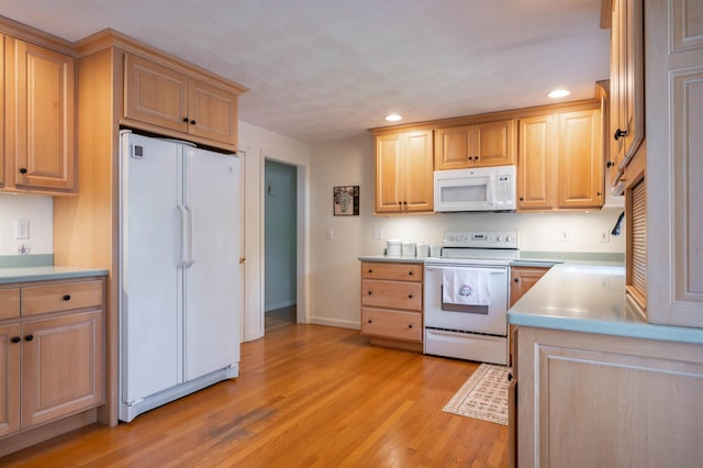 kitchen featuring white appliances, recessed lighting, light brown cabinetry, light wood-style flooring, and baseboards