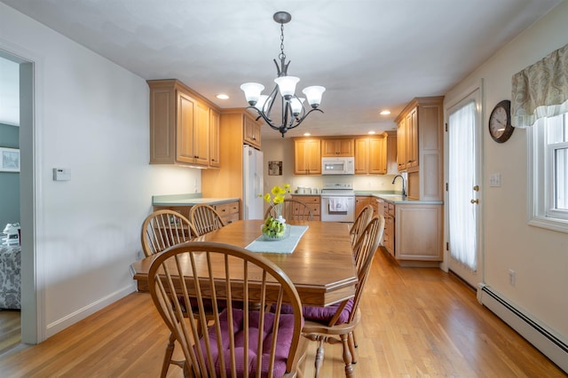 dining area with a baseboard heating unit, a chandelier, light wood-style floors, baseboards, and recessed lighting
