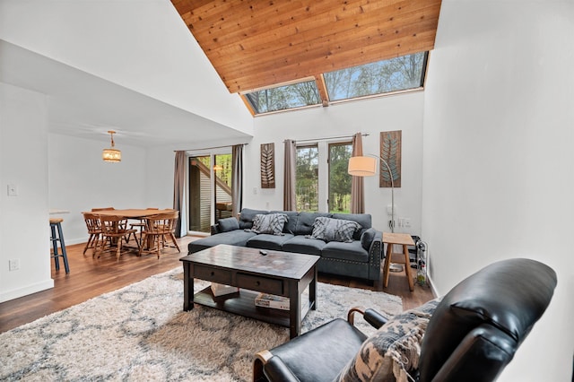 living room with high vaulted ceiling, wood finished floors, and wood ceiling
