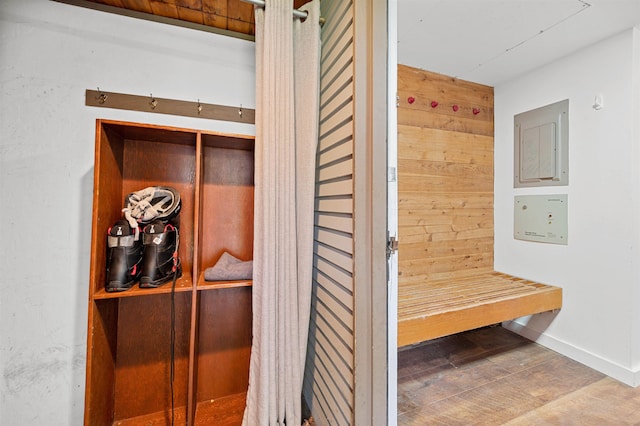 mudroom featuring wood finished floors and baseboards