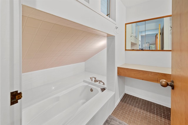 full bath with a garden tub and tile patterned floors