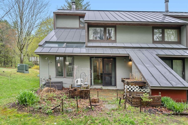 back of house with a standing seam roof and metal roof