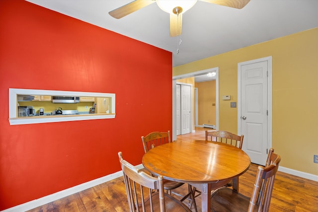 56 Call Rd, Webster, NH 03303 - dining space with baseboards, a baseboard heating unit, wood finished floors, and ceiling fan
