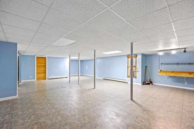 56 Call Rd, Webster, NH 03303 - finished below grade area with a baseboard radiator, baseboards, and a paneled ceiling