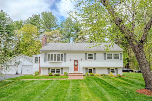1 Alpine Rd, Windham, NH 03087 - split foyer home featuring a chimney, an outdoor structure, a front lawn, a garage, and asphalt driveway