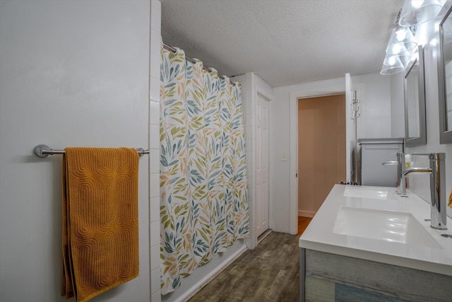 1 Alpine Rd, Windham, NH 03087 - bathroom with wood finished floors, a textured ceiling, a shower with shower curtain, and double vanity