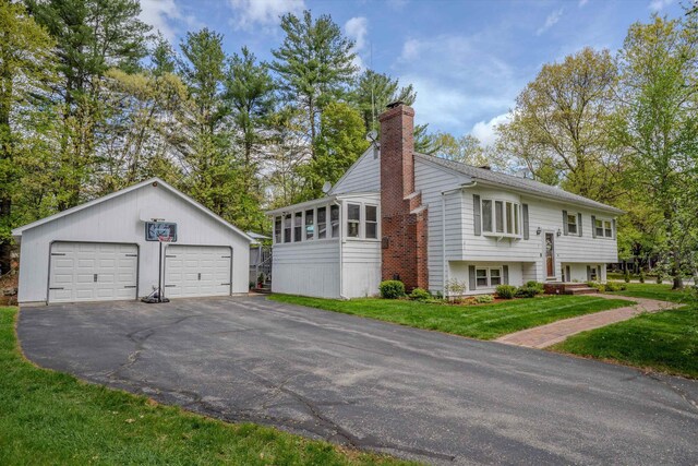 1 Alpine Rd, Windham, NH 03087 - view of side of property with a chimney, an outdoor structure, a garage, and a yard