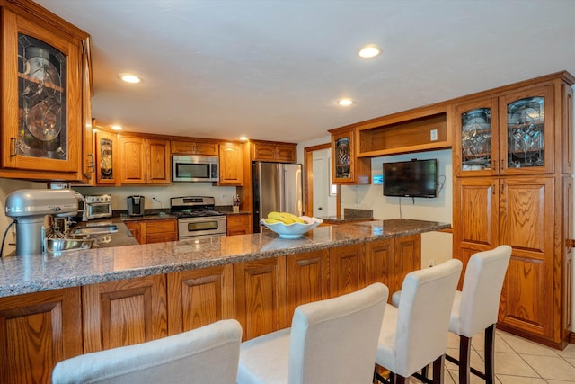 1 Alpine Rd, Windham, NH 03087 - kitchen featuring appliances with stainless steel finishes, brown cabinets, open shelves, a peninsula, and recessed lighting