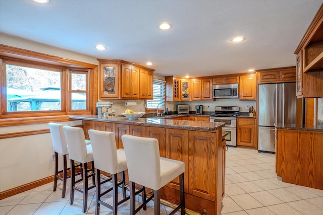 1 Alpine Rd, Windham, NH 03087 - kitchen with stainless steel appliances, a sink, a peninsula, glass insert cabinets, and recessed lighting