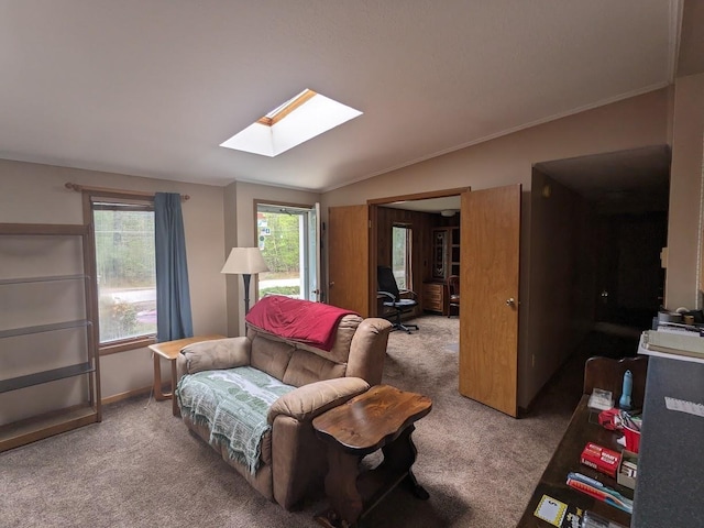 sitting room featuring a skylight, carpet floors, and crown molding