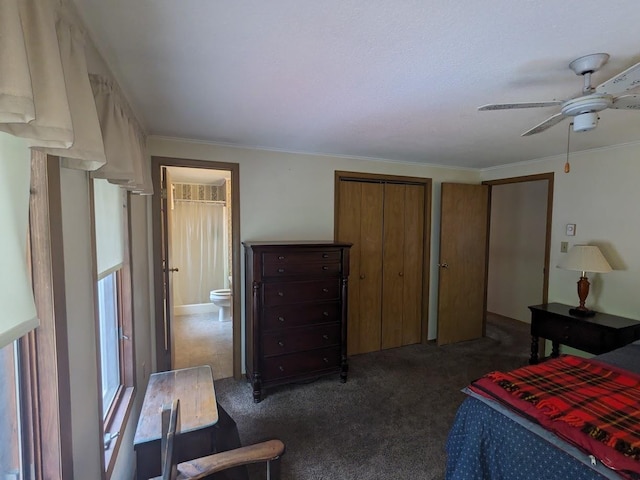 bedroom with connected bathroom, dark carpet, ceiling fan, and ornamental molding