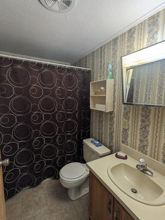 full bathroom with wallpapered walls, a textured ceiling, toilet, vanity, and tile patterned floors
