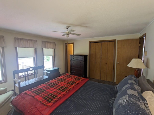 carpeted bedroom featuring a ceiling fan and crown molding