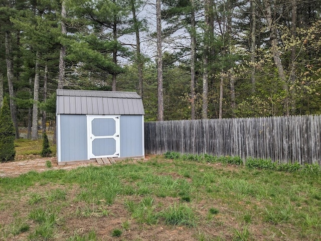 view of shed featuring fence