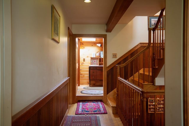 hall with beam ceiling, stairs, wood finished floors, and recessed lighting