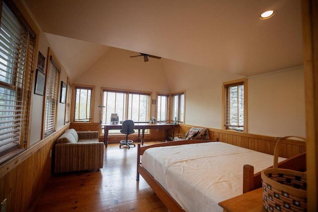 bedroom with a wainscoted wall, wood finished floors, wood walls, recessed lighting, and lofted ceiling