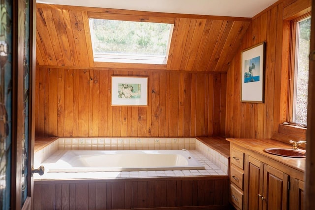 full bath with a garden tub, vanity, and wooden walls