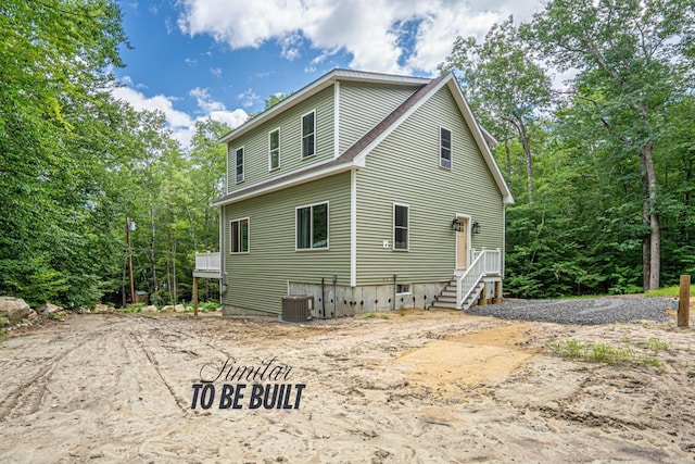 rear view of property with central AC unit