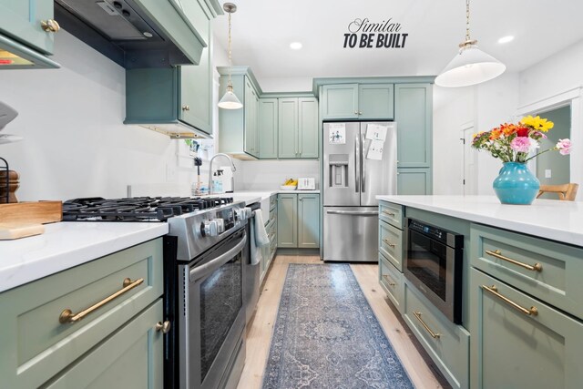 kitchen featuring stainless steel appliances, exhaust hood, green cabinetry, light wood-style flooring, and light countertops