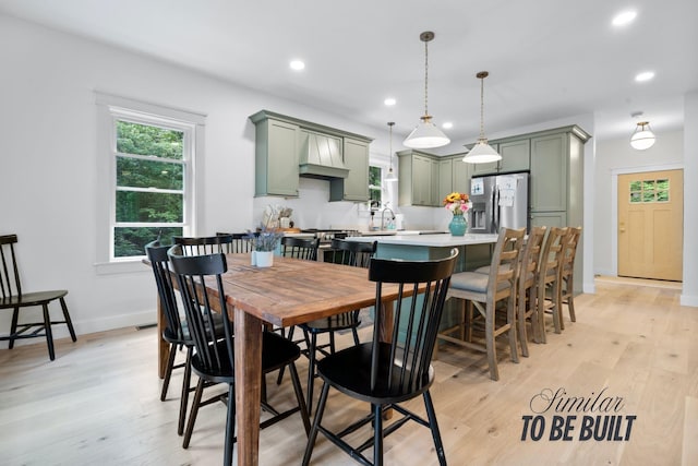 dining room with recessed lighting, light wood-style flooring, and baseboards