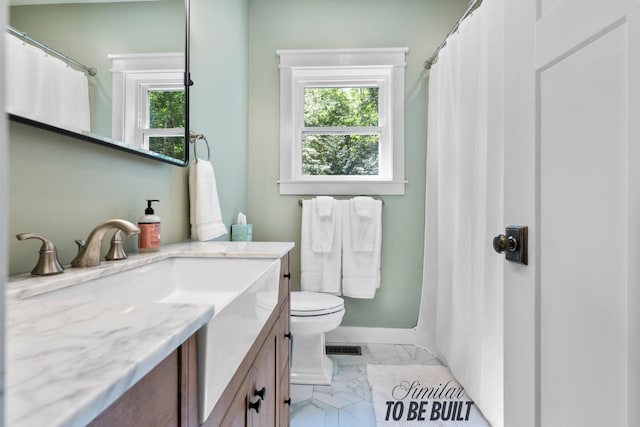 full bath with marble finish floors, vanity, baseboards, toilet, and curtained shower