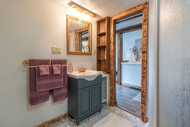 7206 S Wheelock Rd, Wheelock, VT 05851 - bathroom with vanity, a textured ceiling, and wood finished floors