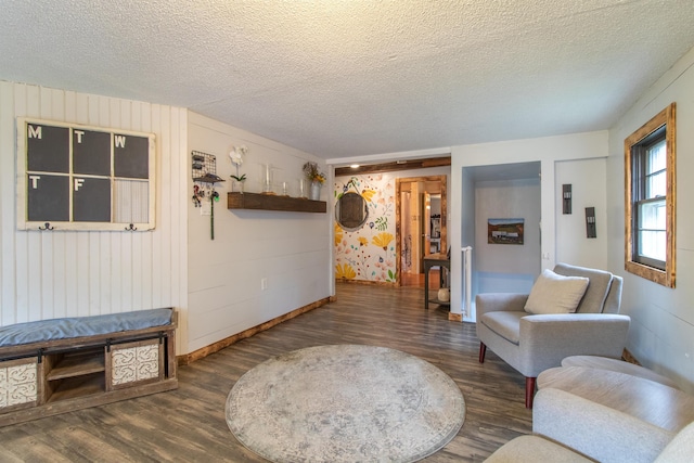 7206 S Wheelock Rd, Wheelock, VT 05851 - living room featuring wood finished floors, baseboards, and a textured ceiling